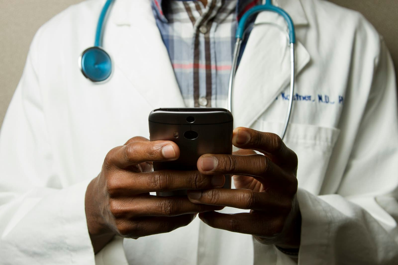 A clinician checking a patient’s details on a phone